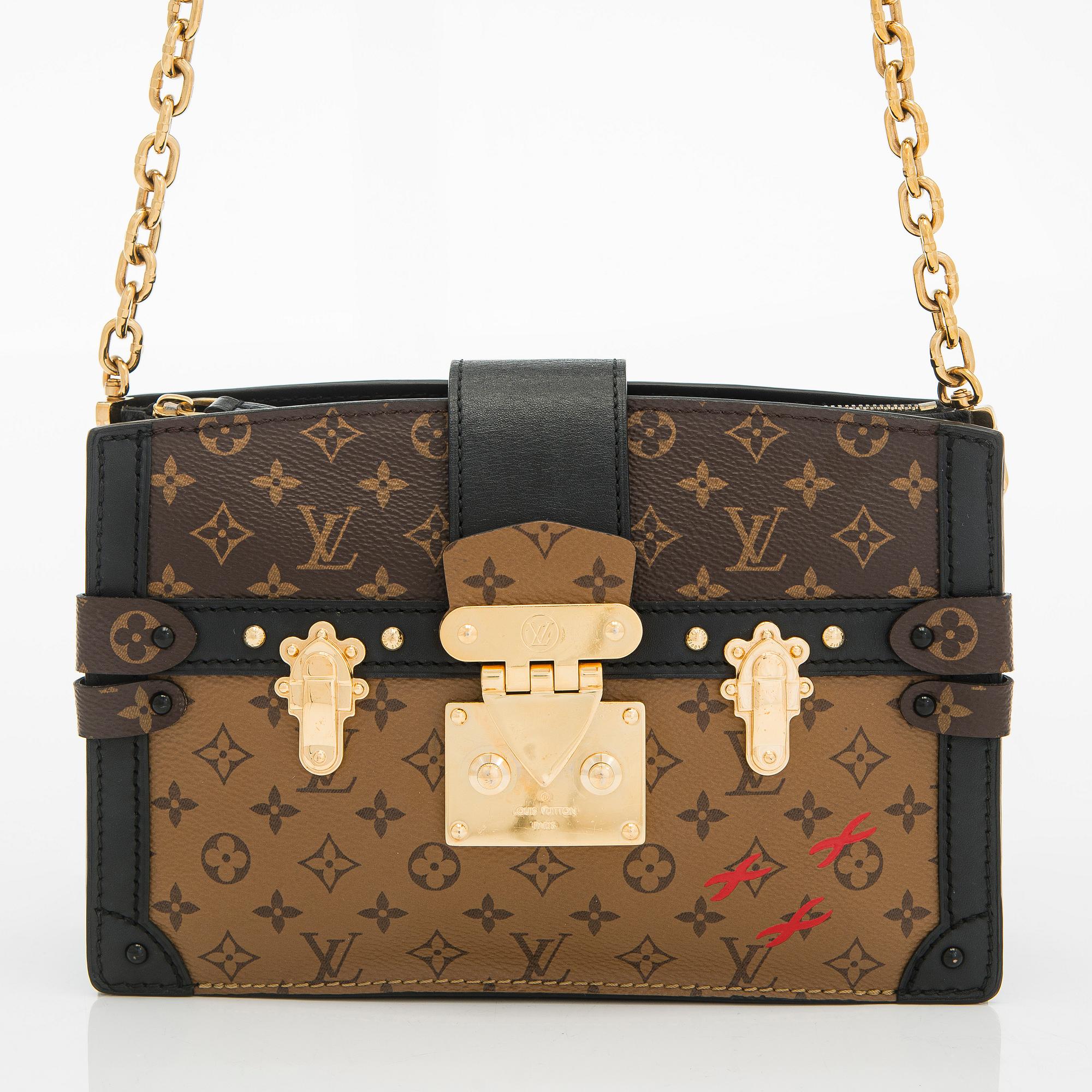 Louis Vuitton, a "Reverse Monogram Trunk Clutch" bag.