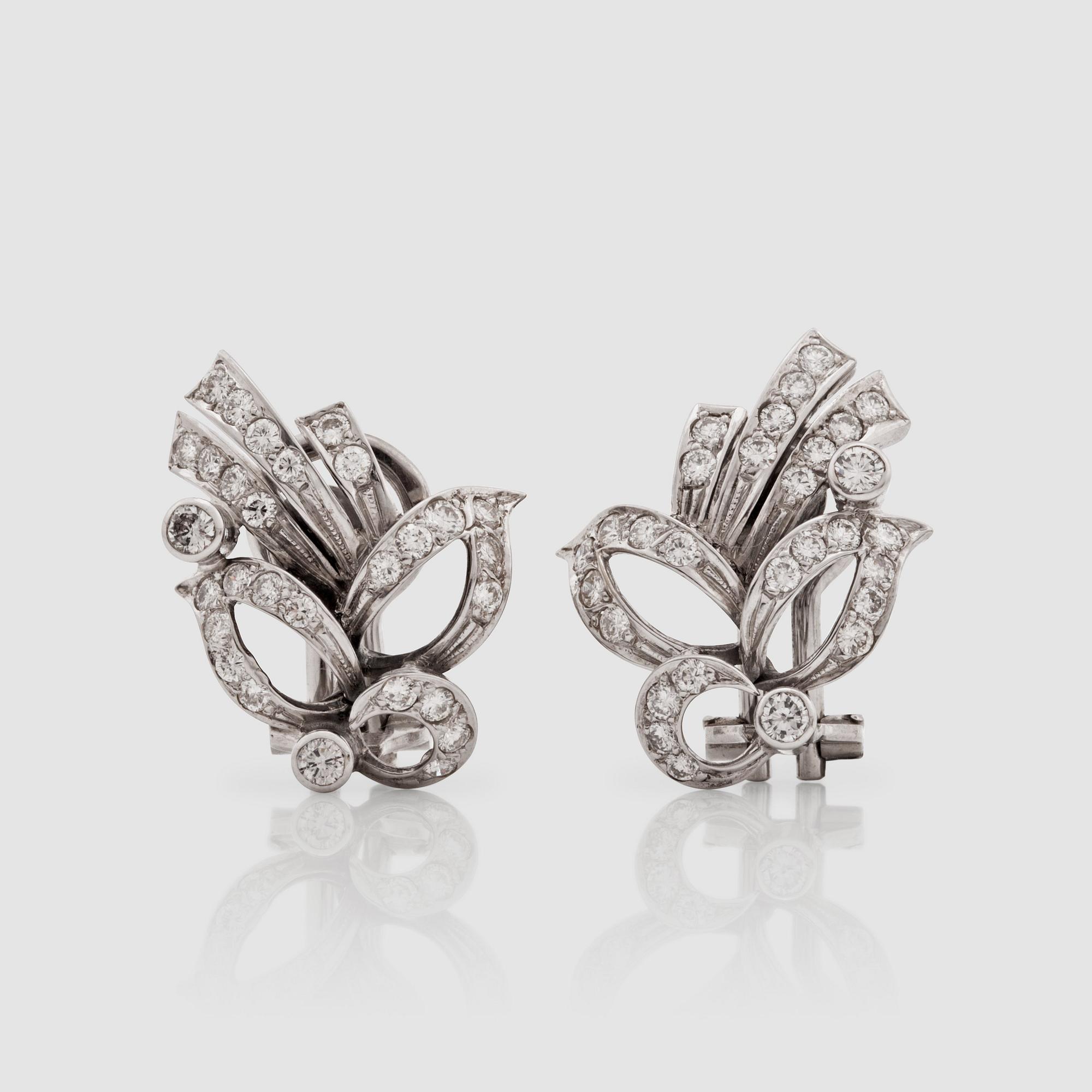 A pair of brilliant-cut diamond earrings.