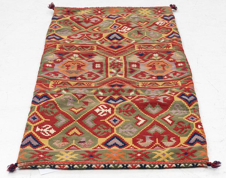 A double-interlocked tapestry carrige cushion, c 100 x 50 cm, Scania, mid 19th century.