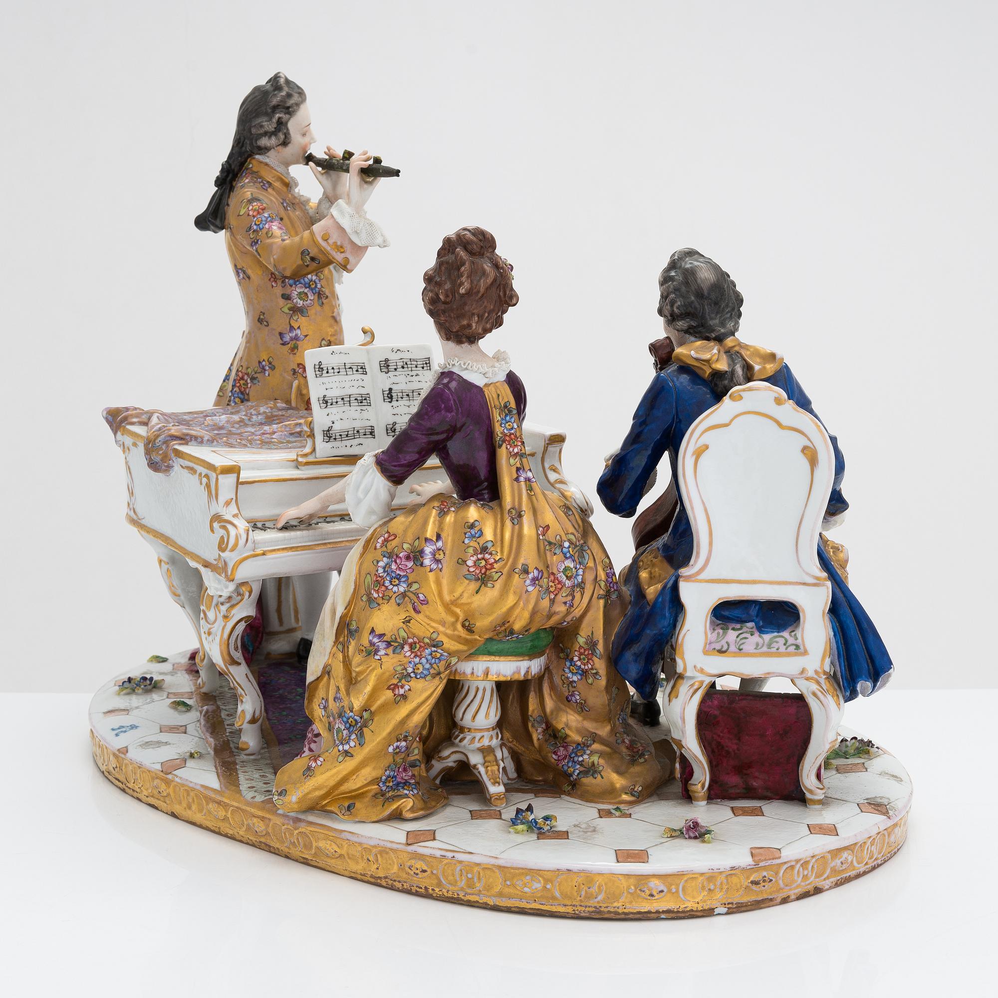 A Volkstedt porcelain musical trio figurine, mid-20th century. Length 40 cm.