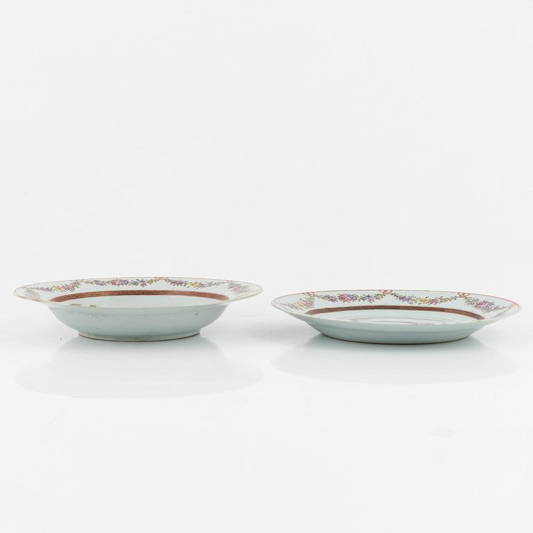 Six Famille Rose plates, and a blue and white dessert dish, China, 18th century.