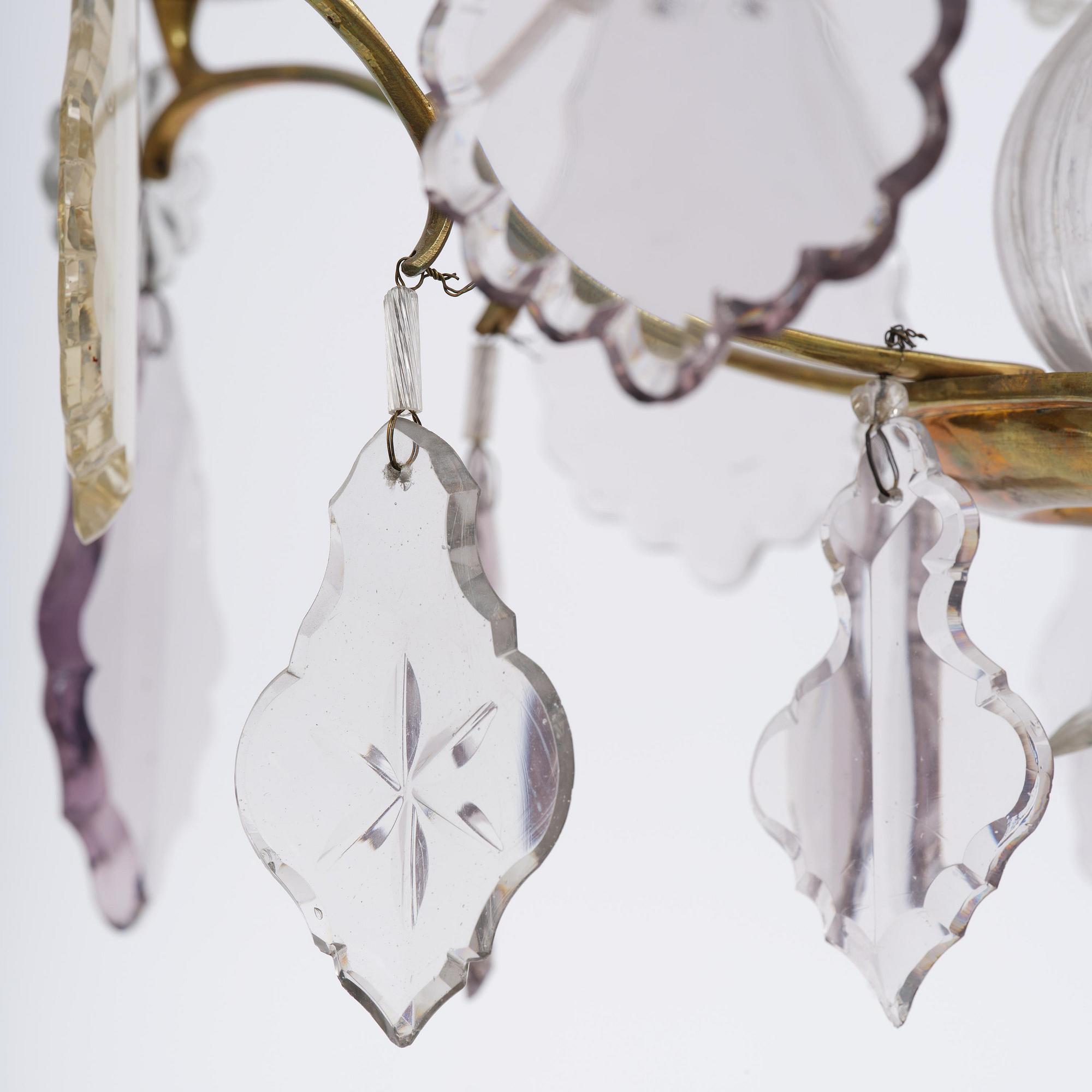 A near pair of rococo-style gilt brass and cut glass six-branch chandeliers, 19th century incorporating older elements.