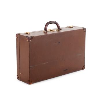 LOUIS VUITTON, a brown faux leather suitcase from around 1910.