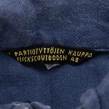 Two Finnish girl scouts uniforms with accessories and a boardgame, mid-second half of 20th Century.