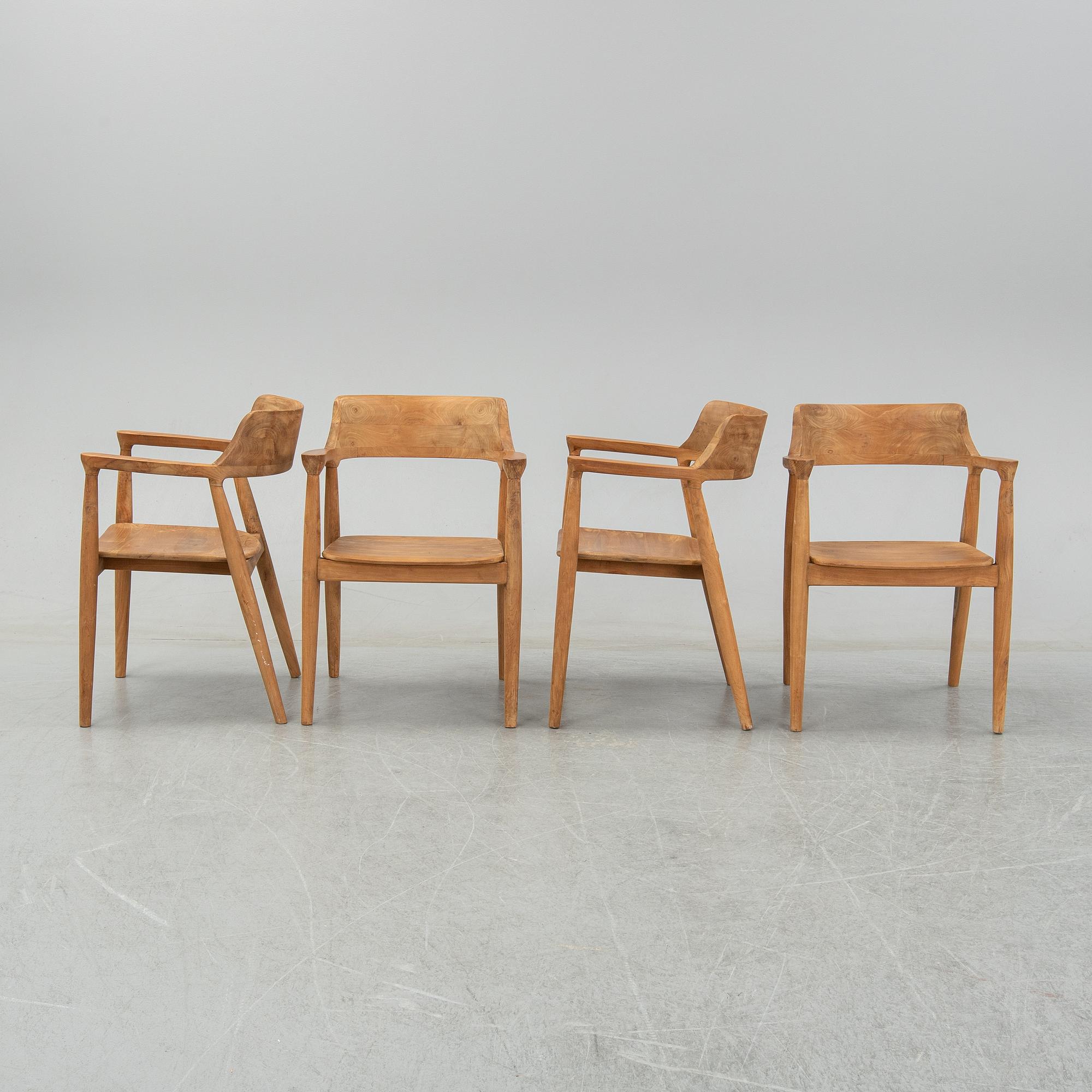 Four contemporary teak armchairs.