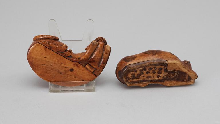 Two 19th-20th century birch snuffboxes in the shape of lying dogs.