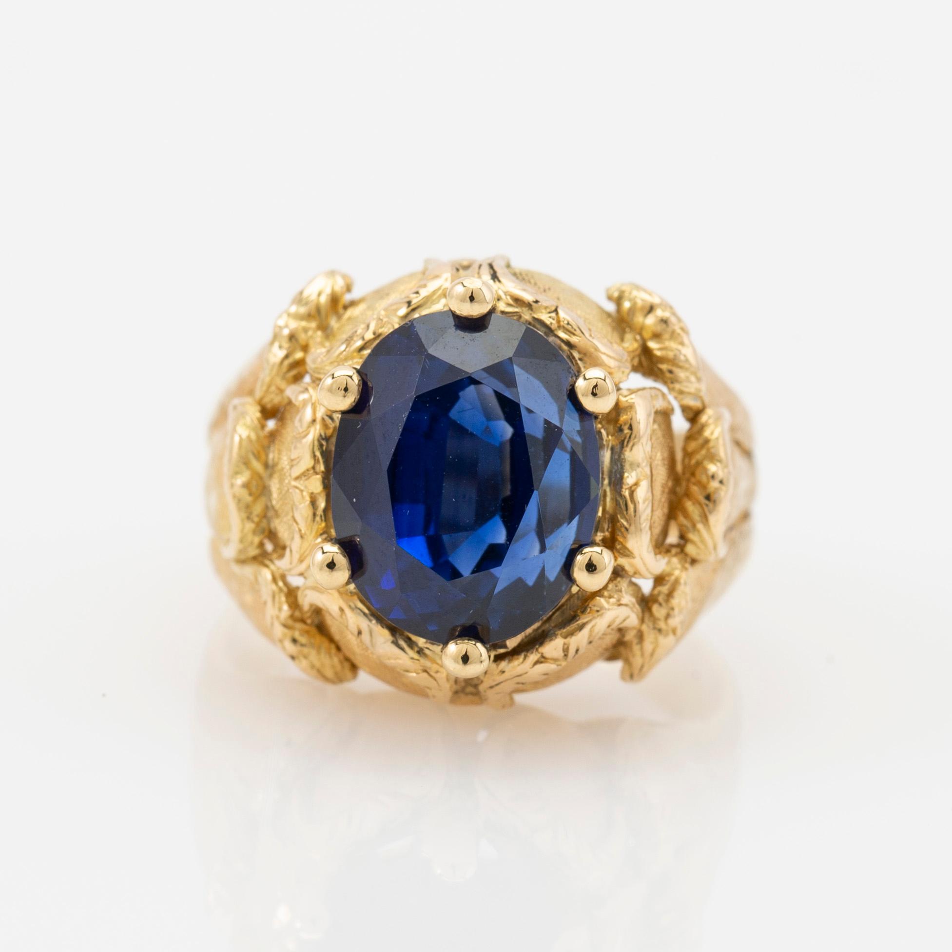 Ring, 18k gold with blue stone, possibly sapphire.