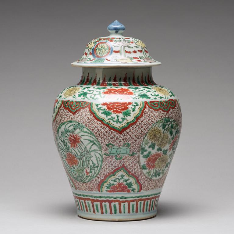 A Transitional wucai baluster vase with cover, 17th Century.