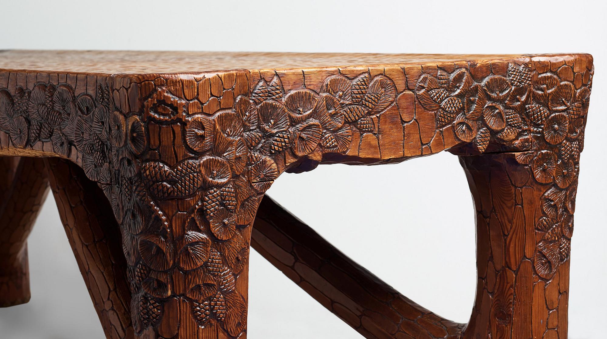 Gustaf Fjaestad, an Art Nouveau carved pine table, Arvika Sweden 1914, a double to the table in the Thiel Collection,