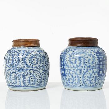 Two similar Chinese blue and white porcealin jars with wooden covers, Qing dynasty, 19th Century.