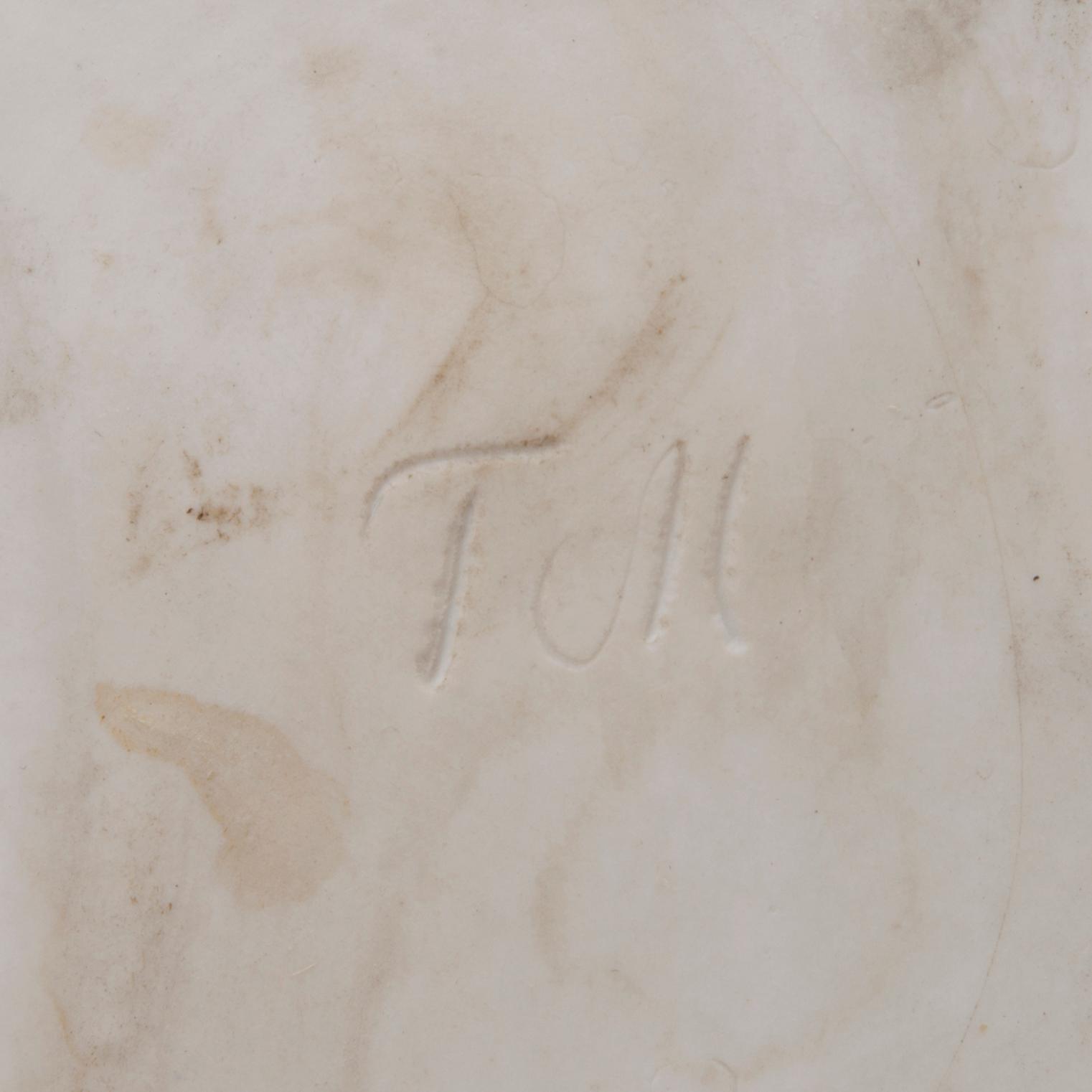 A mid-20th century glazed ceramic dish, signed TM.