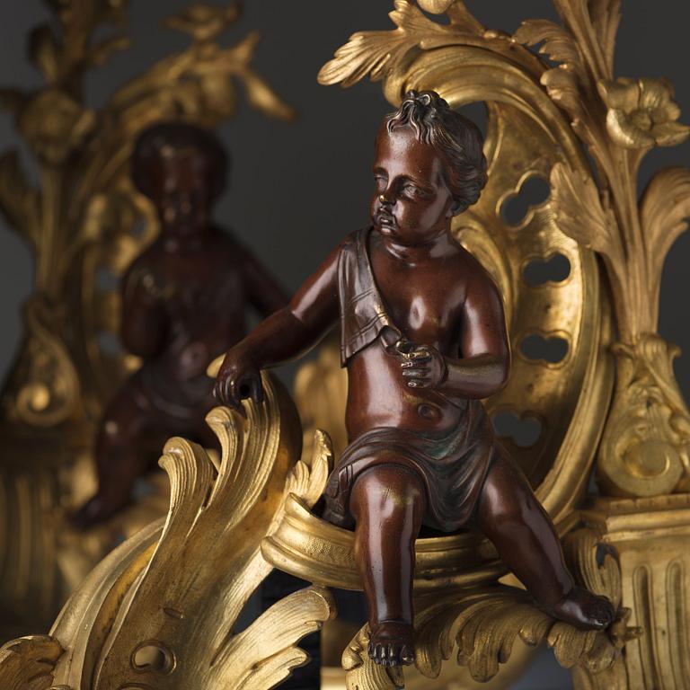A pair of Louis XV-style 19th century fire dogs.