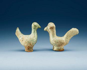 A set of two green glazed pottery models of a rooster and a hen, Han dynasty (206 BC- 220 AD).