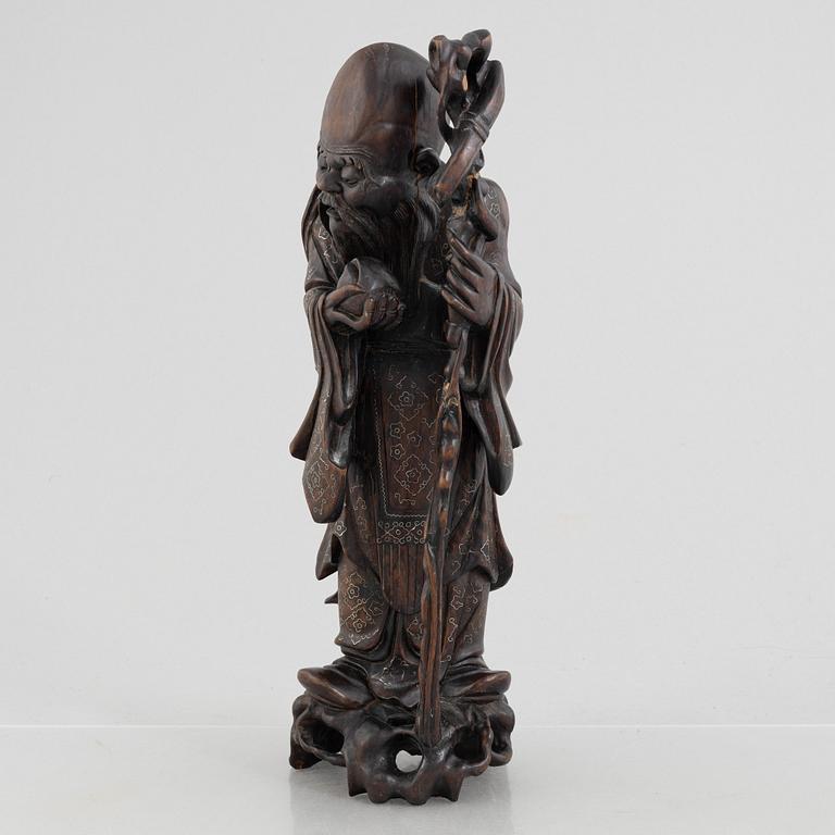 A Chinese wooden figure of 'Shoulao' with silver inlays, 20th century.