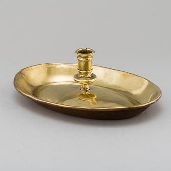 An 18th century brass candlestick.