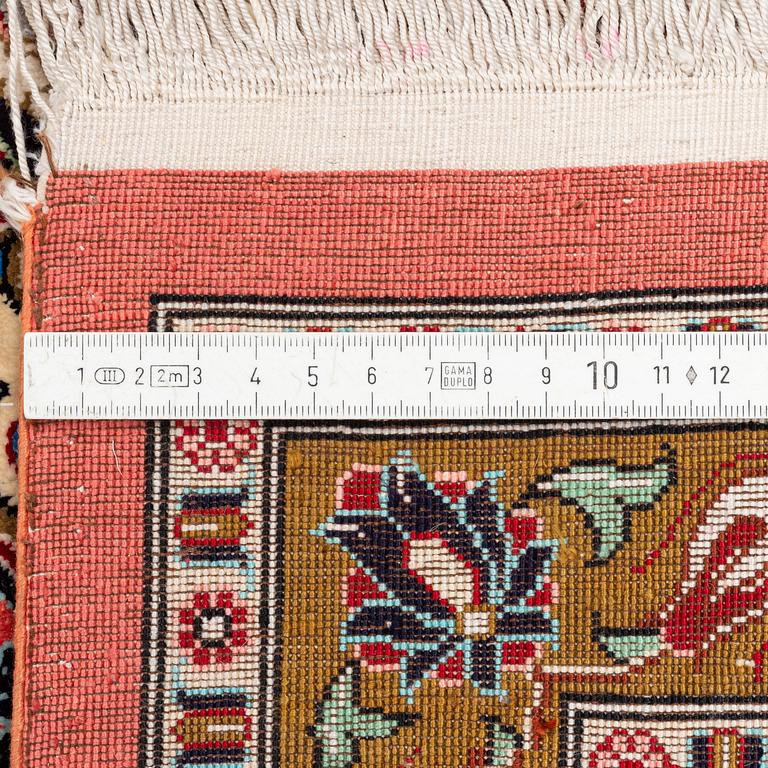 A 1960's silk Qum carpet, c. 305 x 205 cm (as well as 4 and 2 cm of flat weave on each side).