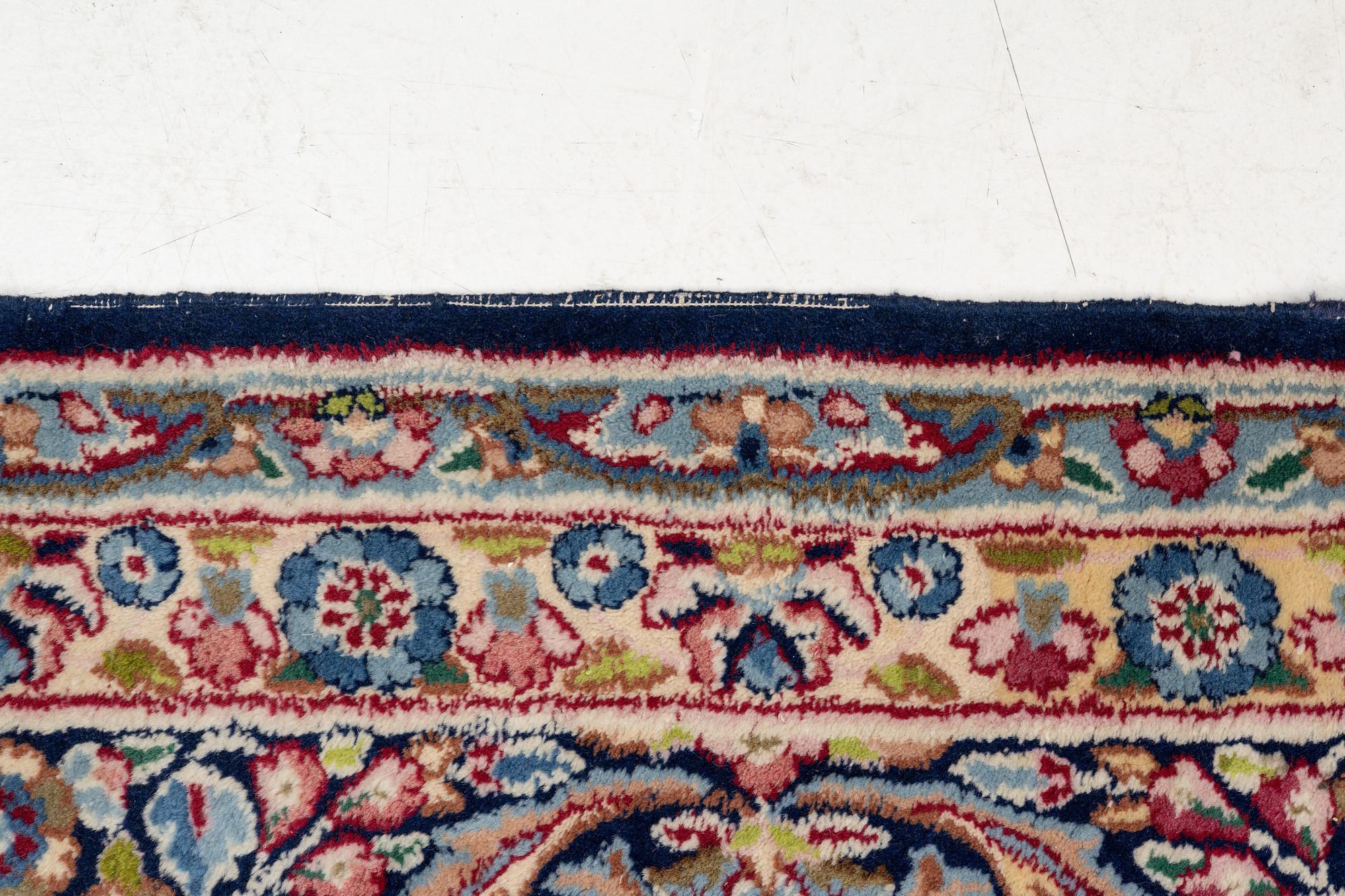 An oriental carpet, c. 385 x 300 cm.