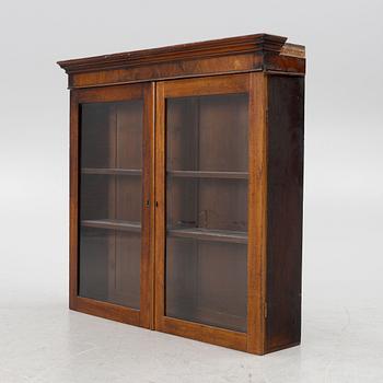 A mahogany veneered vitrine wal cabinet.