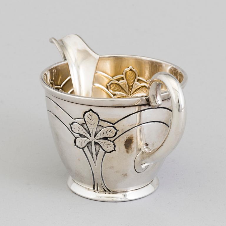 A Danish Art Nouveau parcel-gilt cream jug, maker's mark Franz Hingelberg, Aarhus 1909.