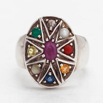 A sterling silver ring with multicoloured precious stones.