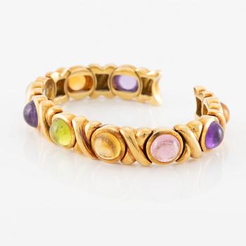 Bracelet in 18K gold set with cabochon-cut citrine, amethyst, pink tourmaline, peridot, and aquamarine.