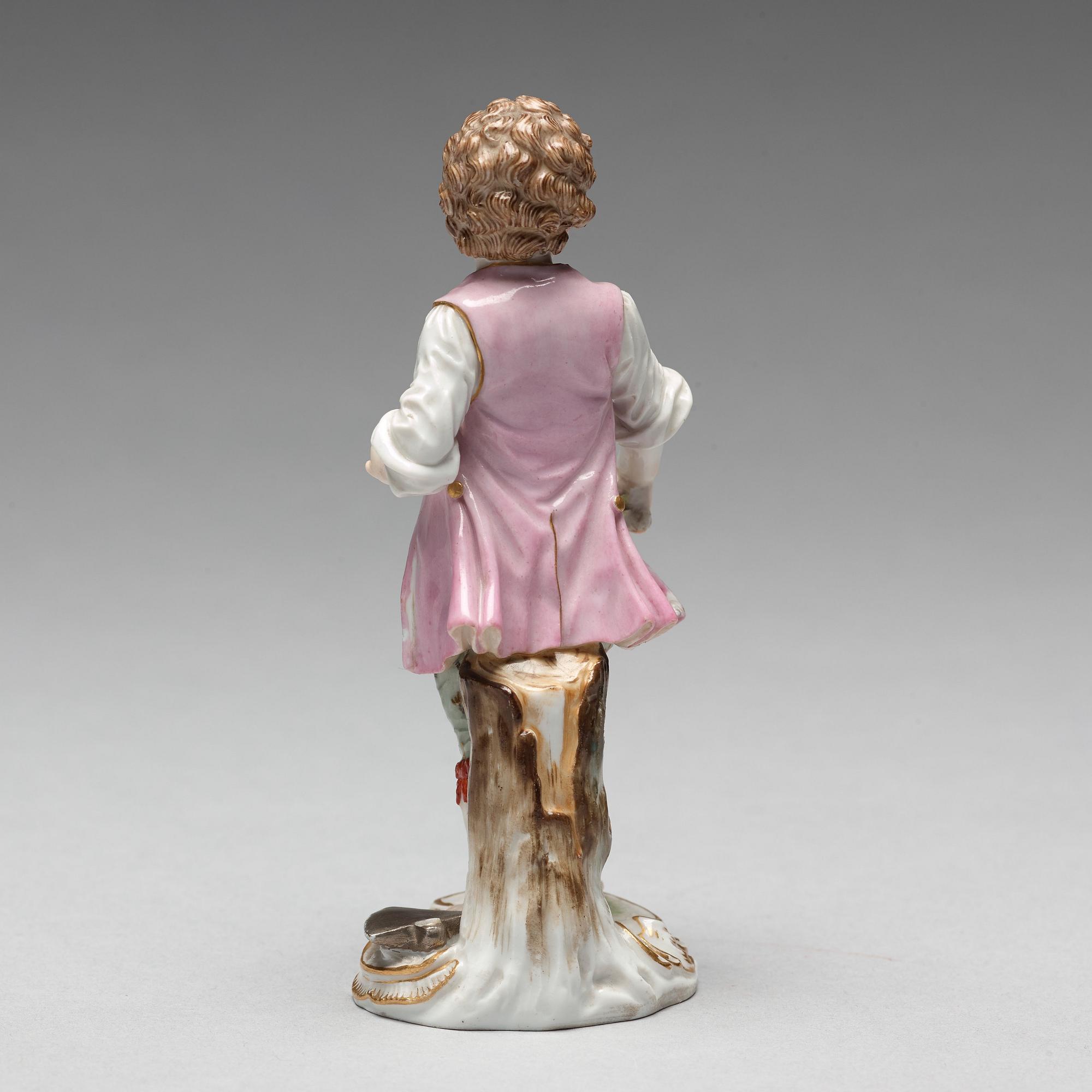 A Meissen figure of a young boy with grapes, 1890's.