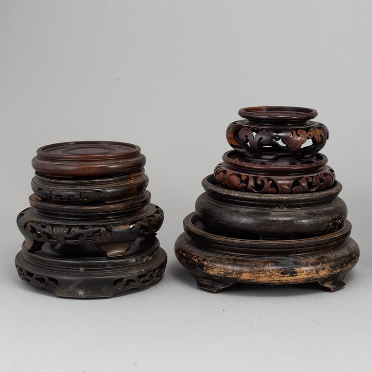 A set of 22 Chinese wooden stands, mostly 20th Century.