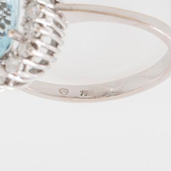 Ring 18K white gold set with an oval faceted aquamarine and round brilliant-cut diamonds.