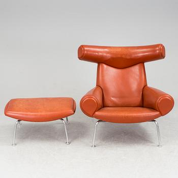 An "Ox-Chair" and foot stool by Hans J Wegner for Erik Jorgensen, Denmark.