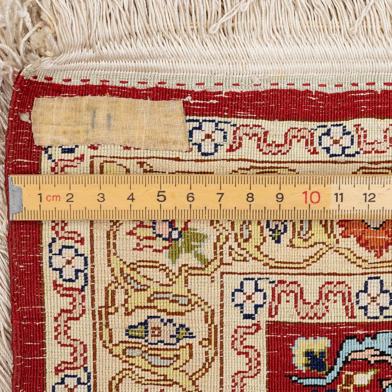 A silk and metal Hereke rug, West Anatolia, c. 58 x 39 cm.