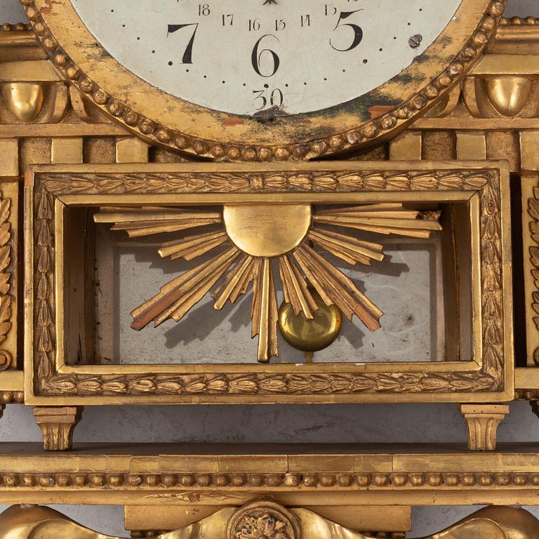 A Gustavian wall clock, late 18th century.