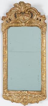 A Swedish gitlwood Rococo mirror, Stockholm, late 18th Century.