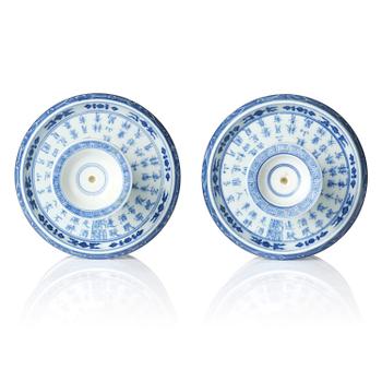 A pair of blue and white pricket candle sticks, with a poem, Qing dynasty with a Qianlong mark and of the period.