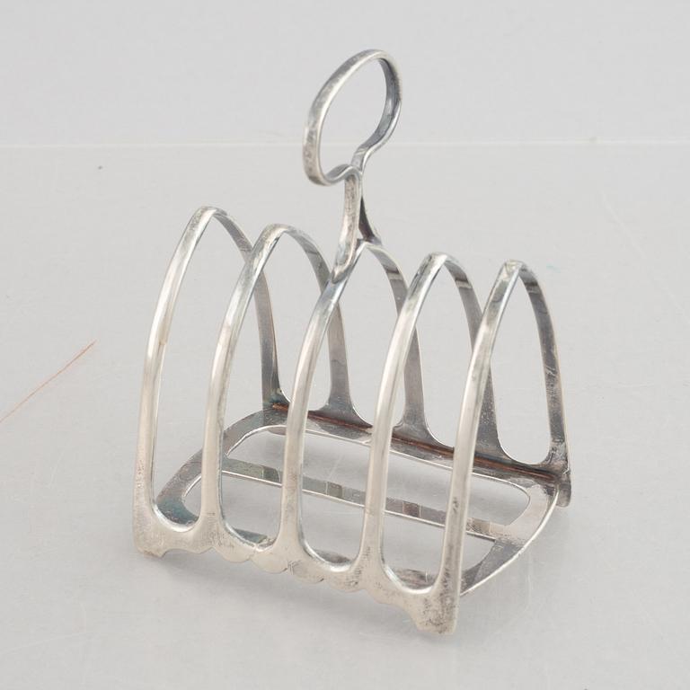 A set of four English silver salt cellars and a toast rack, including Roberts & Belk, Sheffield, England 1898.
