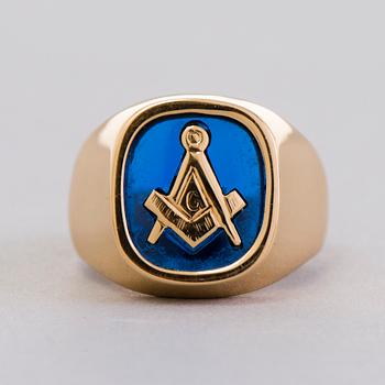 A gold 18K Freemason ring with a synthetic blue sapphire.