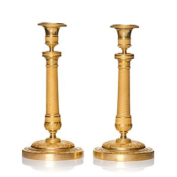 A pair of French gilded Empire candlesticks, early 19th century.