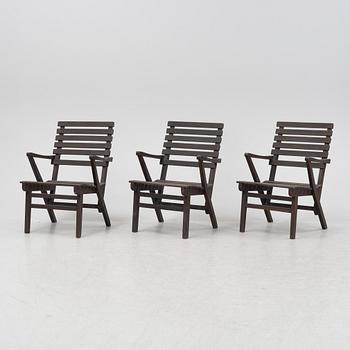 Carl Malmsten, a set three stained pine armchairs, Igelstaverken, second half of the 20th Century.