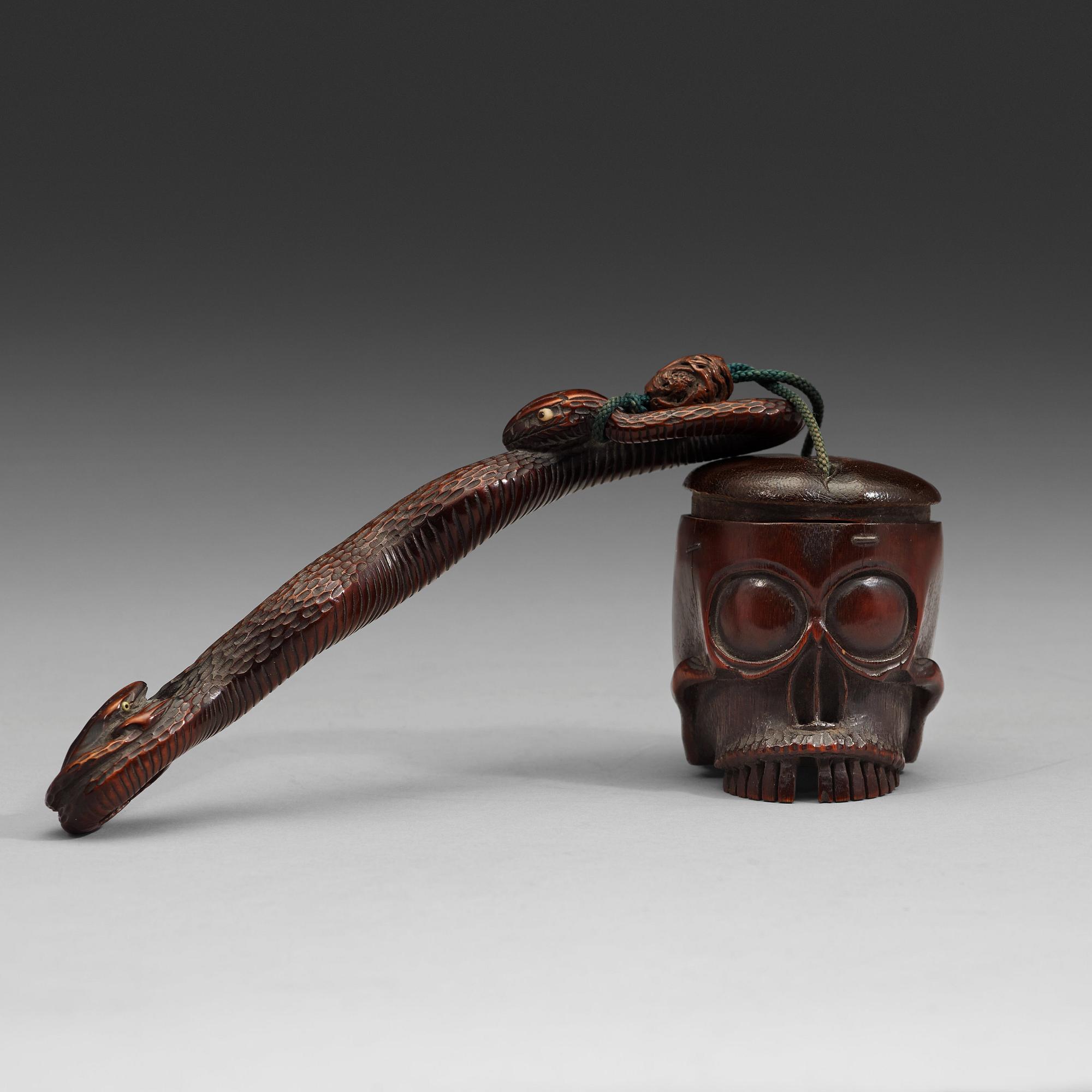 A Japanese bamboo box in the form of a skull with snake, Meiji period (1868-1912).