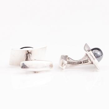 A set of three pairs of silver cufflinks with hematite, tigers eye and granite. Turun Hopea and Osvald Mättö.