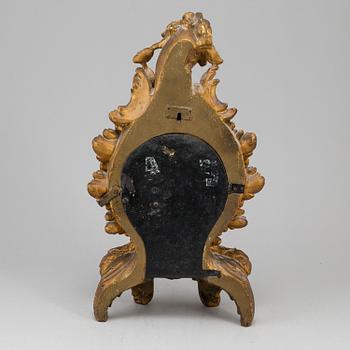A swedish rococo gilt wood mantle clock.