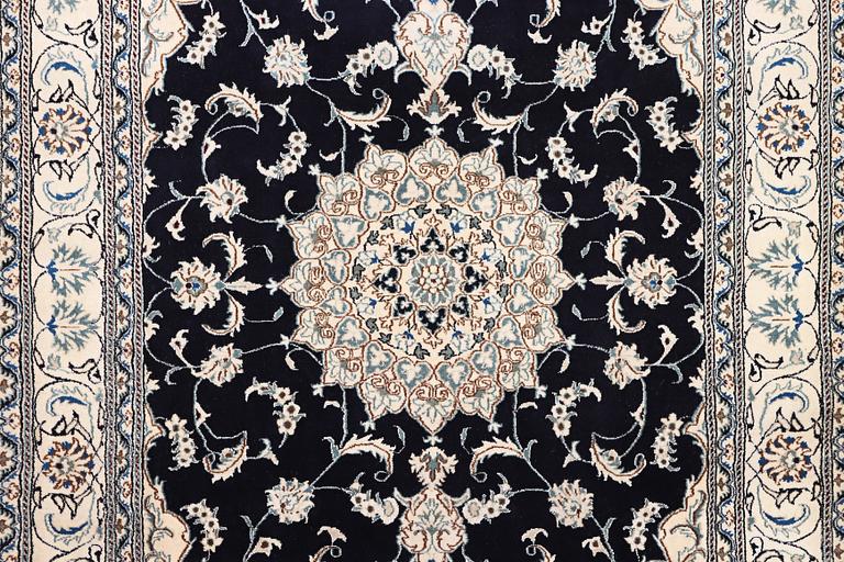 A Nain carpet, part silk, c. 303 x 200 cm.