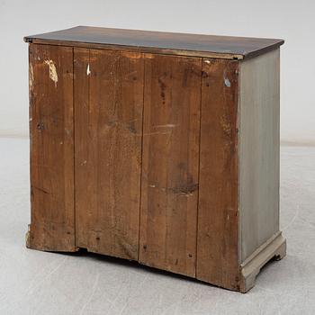 a chest of drawers from the first half of the 19th century.