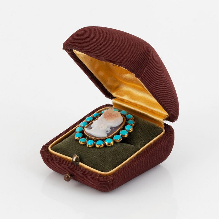 A hardstone cameo brooch with a detachable turquoise frame.