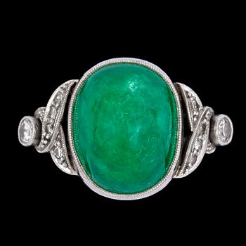 1137. A cabochon cut emerald and diamond ring.