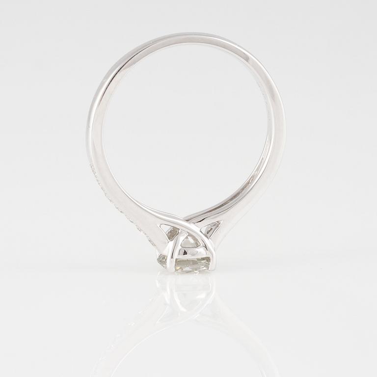 RING, 18K vitguld med briljantslipad diamant ca 0.70 ct samt små briljantslipade diamanter ca 0.15 ct. Vikt 2,9 gram.