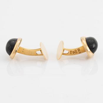 18K gold and cabochon cut blue stone cufflinks.