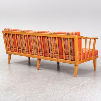 A Swedish 1960s Carl Malmsten pine wood sofa.