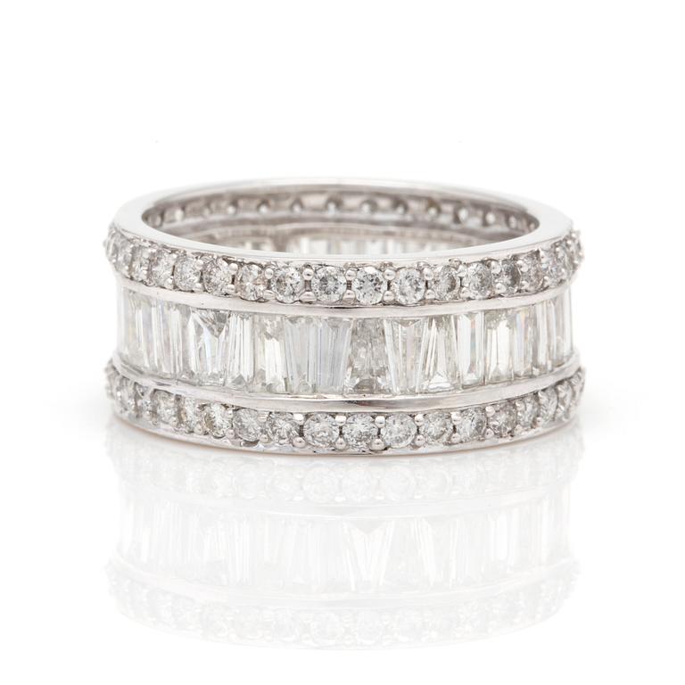A ring with round, brilliant-cut and tapered, baguette-cut diamonds.