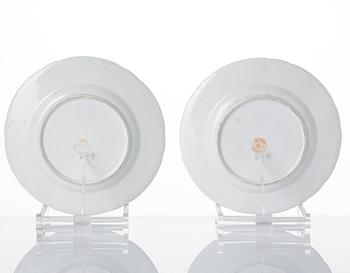 A pair of armorial butter tureens with covers and stands and two fruit dishes, Derby, England, circa 1830.