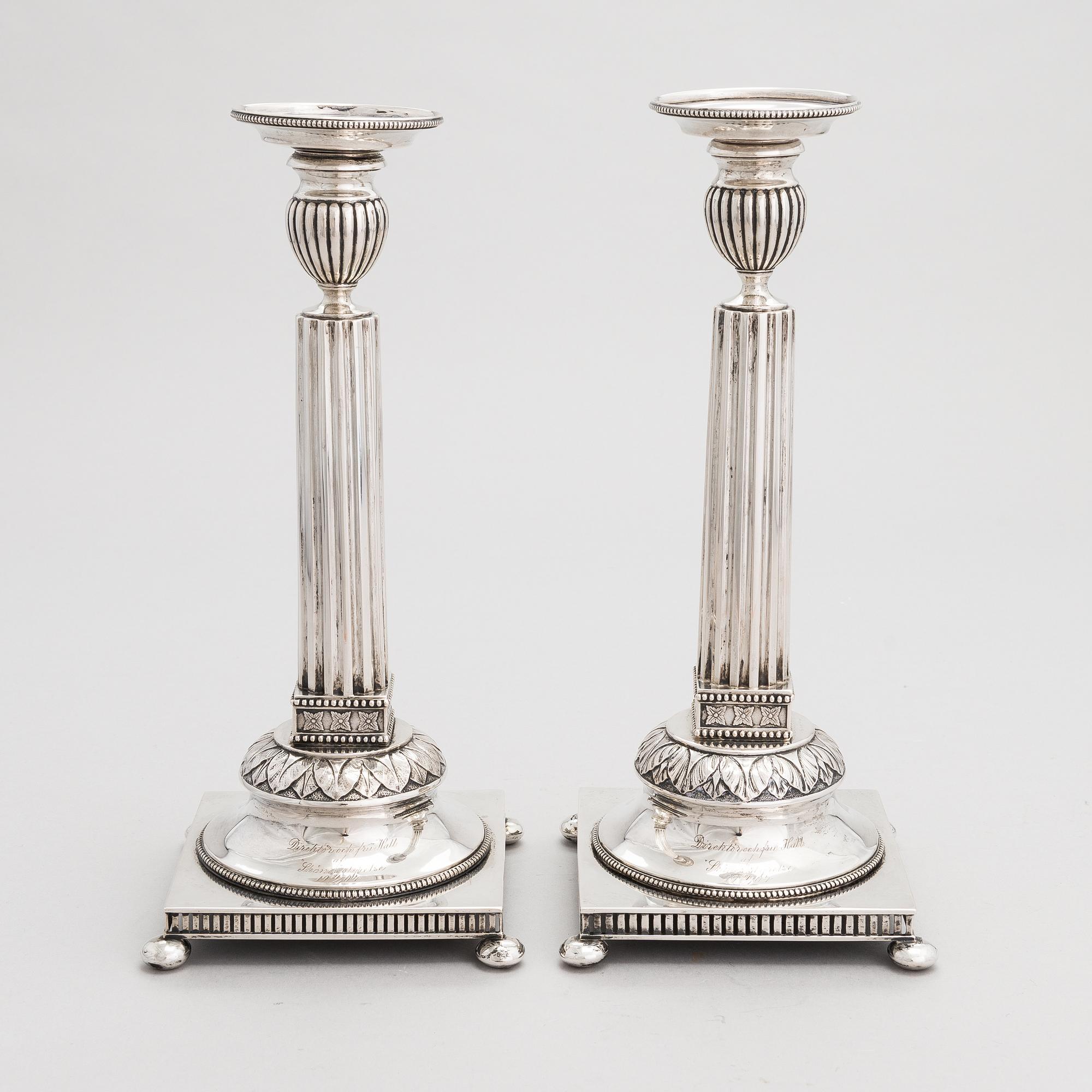 A pair of Swedish silver candlesticks, CG Hallberg, Stockholm 1901 and 1902.